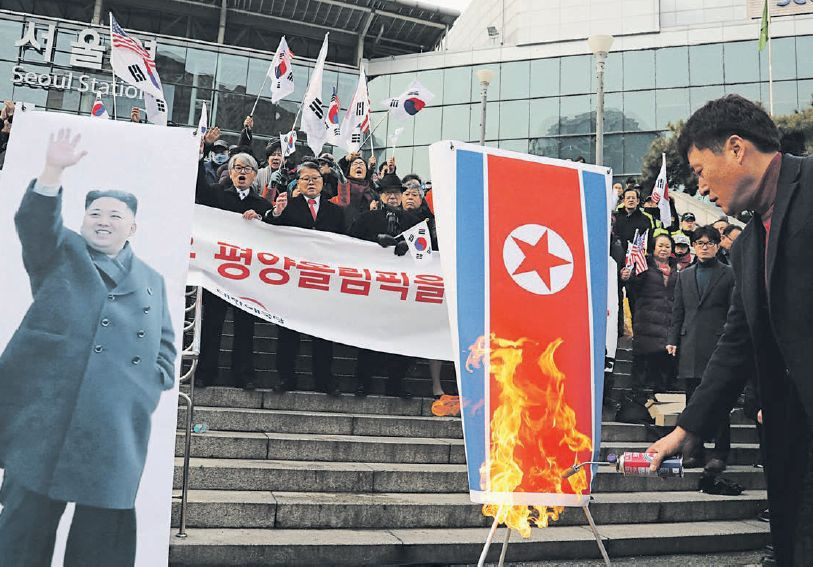 Konzervatívni Juhokórejčania pália v Soule severokórejskú vlajku na protest proti bližšej spolupráci so severným susedom.