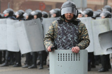 Kazašský policajt dohliada na bezpečnosť počas protestu vyvolaného zvýšením cien pohonných hmôt v Almaty.