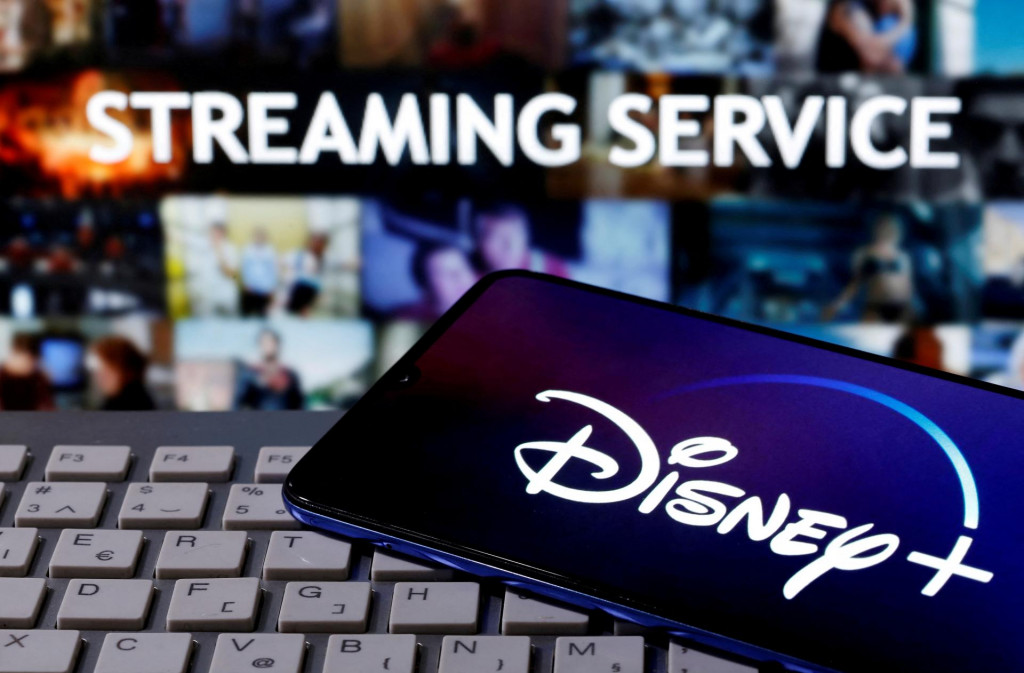 FILE PHOTO: A smartphone with displayed ”Disney” logo is seen on the keyboard in front of displayed ”Streaming service” words in this illustration taken March 24, 2020. REUTERS/Dado Ruvic/File Photo