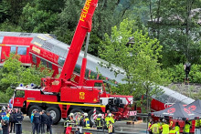 Hasiči pomocou ťažkej techniky pátrajú po obetiach vykoľajeného poschodového regionálneho vlaku neďaleko bavorského mesta Garmisch-Partenkirchen. FOTO: Reuters