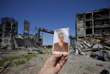 Novinár drží fotografiu ukrajinského vojaka, ktorú našiel v ruinách oceliarní Azovstaľ, 13. júna 2022. FOTO: TASR/AP