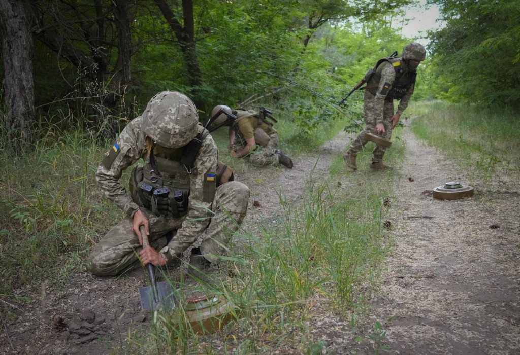Príslušníci ukrajinskej vojenskej špeciálnej jednotky kladú protitankové míny DM22 darované Nemeckom. FOTO: TASR/AP
 
