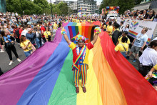 &lt;p&gt;Muž pózuje na veľkej dúhovej vlajke pred začiatkom londýnskeho pochodu Pride. FOTO: TASR/AP&lt;br /&gt;
 &lt;/p&gt;