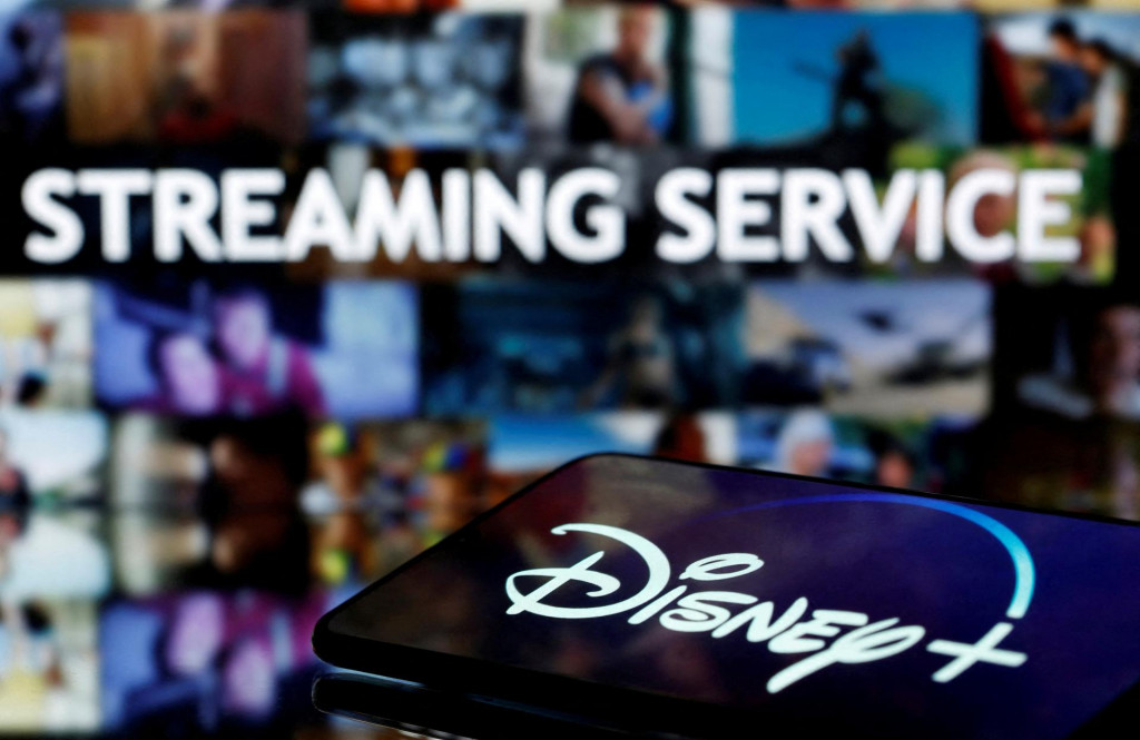 FILE PHOTO: A smartphone screen showing the ”Disney+” logo is seen in front of the words ”streaming service” in this illustration taken March 24, 2020. REUTERS/Dado Ruvic/File Photo