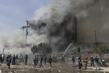 Hasiči hasia plamene pri požiari v obchodnom centre v arménskom meste Surmalu, 2 km južne od Jerevanu 14. augusta 2022. FOTO: TASR/AP