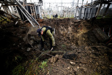 Vyšetrovatelia skúmajú kráter po údere ruskej rakety na zariadenie elektrického transformátora v Charkove. FOTO: REUTERS
