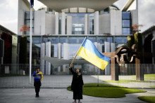 Žena mavájúca ukrajinskou vlajkou. FOTO: TASR/AP