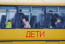 Deti evakuované z okupovaného Chersonu čakajú v autobuse, na ktorom je azbukou napísané slovo ”deti”. FOTO: REUTERS