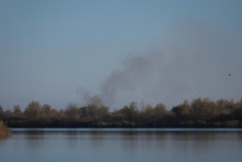 Smoke rises after shelling at an opposite side of the Dnipro river as Russia‘s retreat from Kherson, in Kherson, Ukraine November 14, 2022. REUTERS