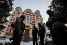 Ukrajinskí strážcovia zákona stoja vedľa Katedrály svätého Juraja, odbočky ukrajinskej pravoslávnej cirkvi vernej Moskve. FOTO: Reuters