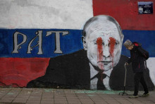 Nástenná maľba zobrazujúca Vladimira Putina v centre Belehradu sa po invázii Ruska zmenila. Zo slova brat sa stala vojna (po srbsky rat). FOTO: Reuters