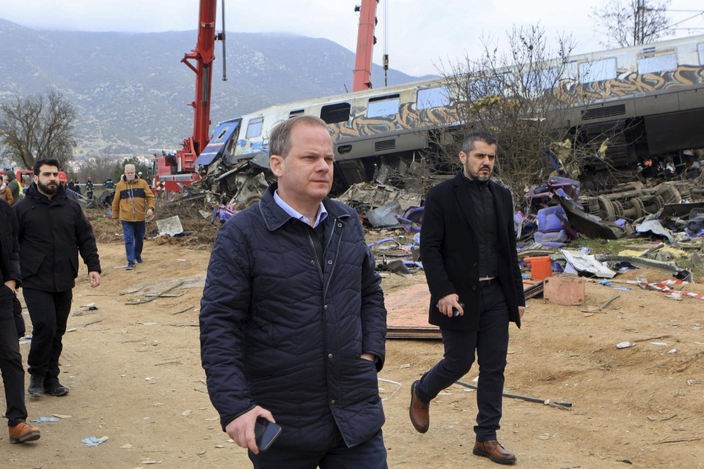 Grécky premiér Kyriakos Mitsotakis (uprostred) počas návštevy miesta tragickej zrážky nákladného a osobného vlaku v blízkosti mesta Larisa na severe Grécka. FOTO: TASR/AP