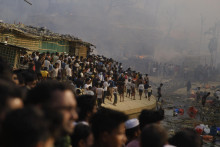 Rohinskí utečenci sledujú masívny požiar, ktorý zachvátil utečenecký tábor pre Rohingov v juhovýchodnom Bangladéši v nedeľu 5. marca. FOTO: TASR/AP