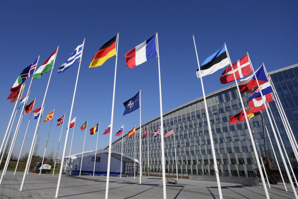 Prázdna žrď medzi vlajkami Francúuzska a Estónska pred sídlom NATO v Bruseli v pondelok 3. apríla 2023. Fínsko sa v utorok stane členom Severoatlantickej aliancie NATO. FOTO: TASR/AP