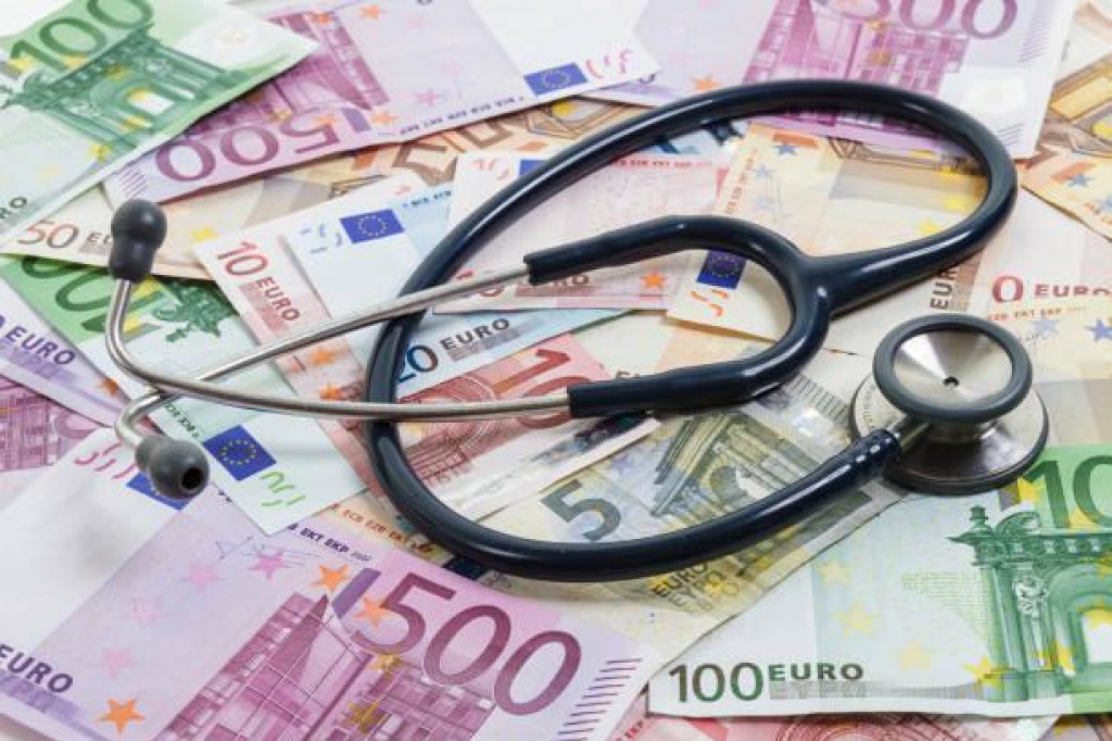 Stethoscope lying on top of various Euro banknotes. Medical cost, insurance, wealth, health, education concept.