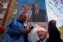 Ľudia prechádzajú okolo transparentov Kemala Kiliçdaroglu, prezidentského kandidáta hlavnej tureckej opozičnej aliancie. FOTO: Reuters