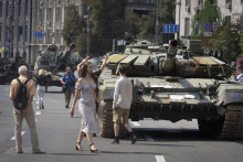 Ľudia si prezerajú zničené ruské tanky vystavené v centre Kyjeva. FOTO: TASR/AP