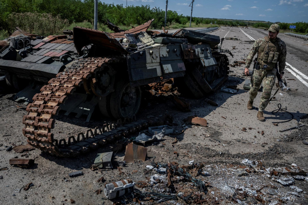 Ukrajinský vojak kráča pri zničenom ukrajinskom tanku pri obci Robotyne. FOTO: Reuters