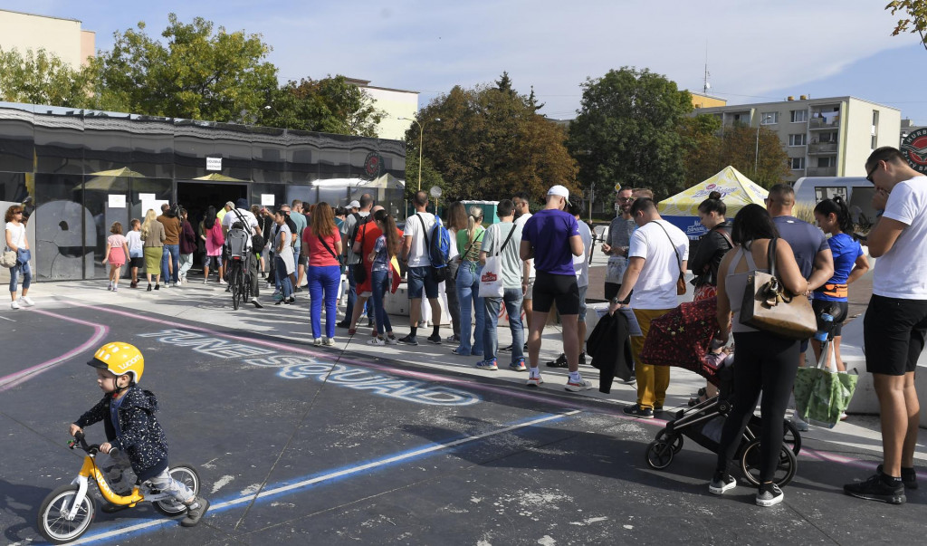 Maratónski bežci po registrácii na Medzinárodný maratón mieru čakajú v rade pred volebnou miestnosťou v Kulturparku v Košiciach. FOTO: TASR/František Iván
