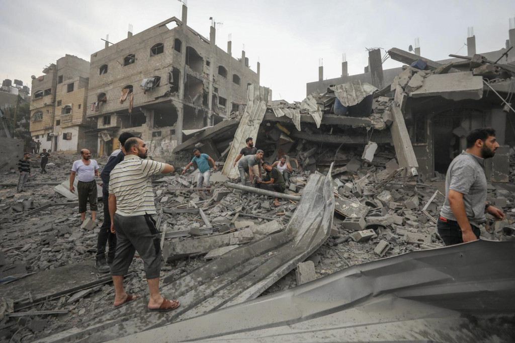 Palestínčania hľadajú preživších po izraelskom leteckom bombardovaní v Džabalíja neďaleko Gazy. FOTO: TASR/AP
