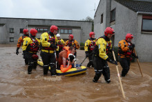 Pohotovostné služby pomáhajú pri evakuácii ľudí z ich domovov v škótskom Brechine uprostred záplav spôsobených búrkou Babet. FOTO: Reuters.