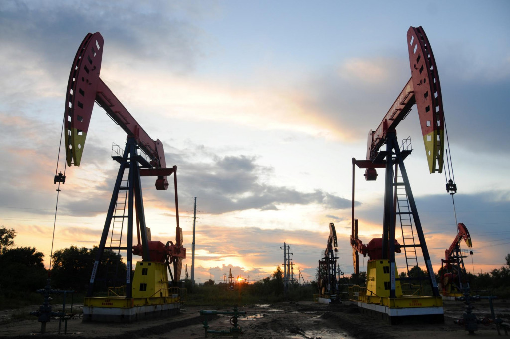Pumpjacks are seen during sunset at the Daqing oil field in Heilongjiang province, China August 22, 2019. Picture taken August 22, 2019. REUTERS/Stringer SNÍMKA: China Stringer Network