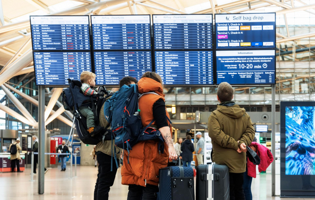 Ilustračná fotografia, cestujúci sa pozerajú na informačnú tabuľu na letisku v Hamburgu. FOTO: TASR/DPA