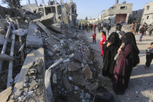 Palestínčania sa pozerajú na škody po izraelskom leteckom útoku v meste Rafah na juhu Pásma Gazy. FOTO: TASR/AP