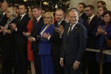 Poľský premiér Donald Tuskstojí pri svojich ministroch počas slávnostného vymenovania novej vlády vo Varšave. FOTO: TASR/AP