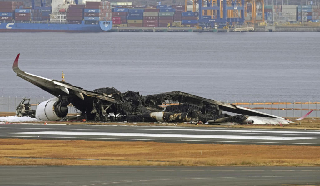 Zhorený vrak lietadla Airbus A350-900 leteckej spoločnosti Japan Airlines na Medzinárodnom letisku v Tokiu. FOTO: TASR/AP
