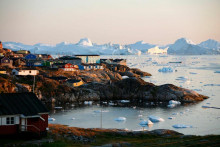 Pohľad na domy a ľadovec Sermeq Kujalleq v Grónsku.