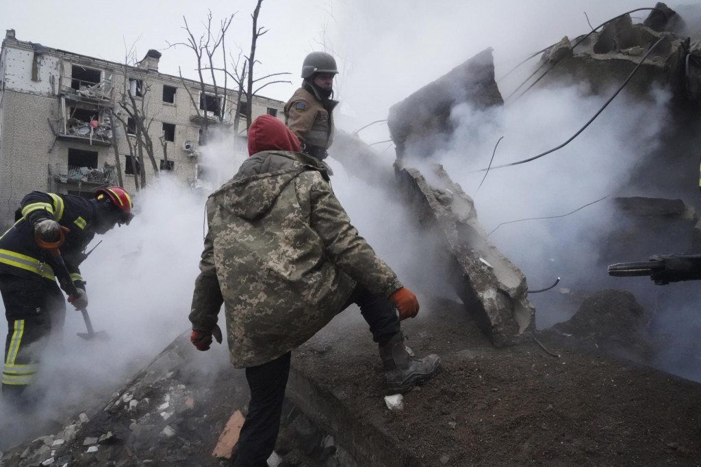 Záchranári zasahujú pred obytnou budovou po ruskom raketovom útoku na ukrajinské mesto Charkov. ILUSTRAČNÉ FOTO: TASR/AP
