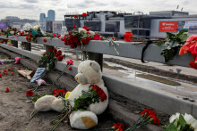 Kvety a hračky sú umiestnené na krajnici pred vyhorenou koncertnou sálou Crocus City Hall na okreji Moskvy. FOTO: Reuters