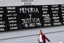 Žena prechádza okolo transparentu s nápisom „Pamäť a spravodlivosť“ a menami obetí bombového útoku v roku 1994 na komunitné centrum argentínskej izraelskej vzájomnej asociácie deň po tom, čo argentínsky najvyšší trestný súd obvinil z útoku Irán. FOTO: Reuters