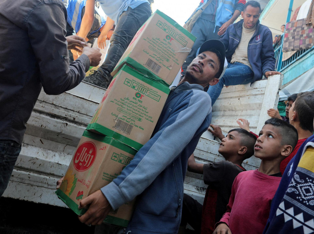 Palestínčania rozdeľujú pomoc uprostred prebiehajúceho konfliktu medzi Izraelom a Hamasom. FOTO: Reuters