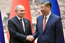 Ruský prezident Vladimir Putin si počas stretnutia v Pekingu podáva ruku s čínskym prezidentom Si Ťin-pchingom.  FOTO: Reuters