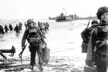 Na archívnej snímke z 6. júna 1944 americké jednotky s plnou výzbrojou sa presúvajú na pláž s kódovým označením Omaha počas spojeneckej invázie na pobreží Normandie. FOTO: TASR/AP