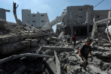 Palestánčania v ruinách Gazy. FOTO: Reuters