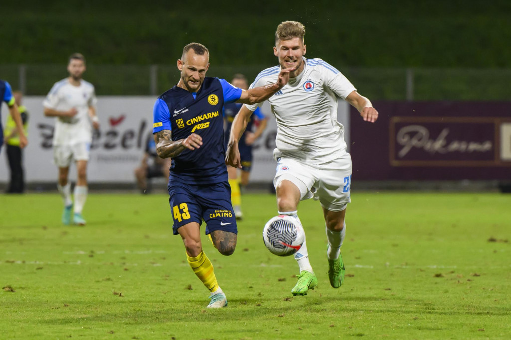 Zľava Aljaž Krefl (Celje) a Alen Mustafič (Slovan) v zápase druhého predkola Ligy majstrov vo futbale NK Celje - ŠK Slovan Bratislava v slovinskom Celje. FOTO: TASR/Jaroslav Novák