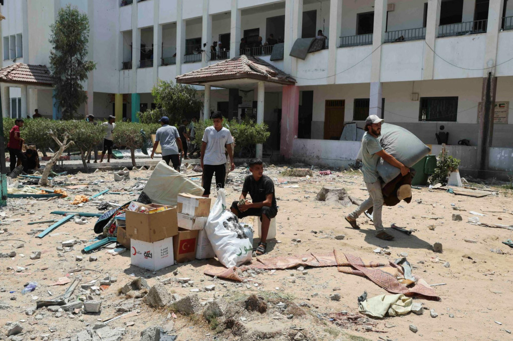 Palestínčania opúšťajú školu, ktorá chráni vysídlené osoby po izraelskom údere uprostred konfliktu medzi Izraelom a Hamasom v Deir Al-Balah v centrálnom pásme Gazy. FOTO: Reuters