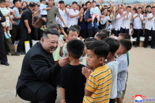 Ilustračná fotografia. Severokórejský vodca Kim Čong-un zdraví deti počas návštevy záplavami postihnutej oblasti okresu Uiju. FOTO: Reuters/KCNA