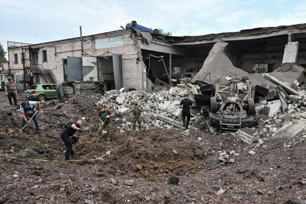 Policajní experti pracujú na mieste ruského raketového útoku v Kryvyjom Rihu. FOTO: Reuters