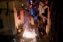 Ľudia sledujú, ako horia petardy počas Díválí, hinduistického festivalu svetiel. FOTO: Reuters