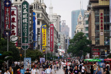 Ľudia sa prechádzajú po hlavnej nákupnej oblasti Nanjing Pedestrian Road v Šanghaji. FOTO: Reuters