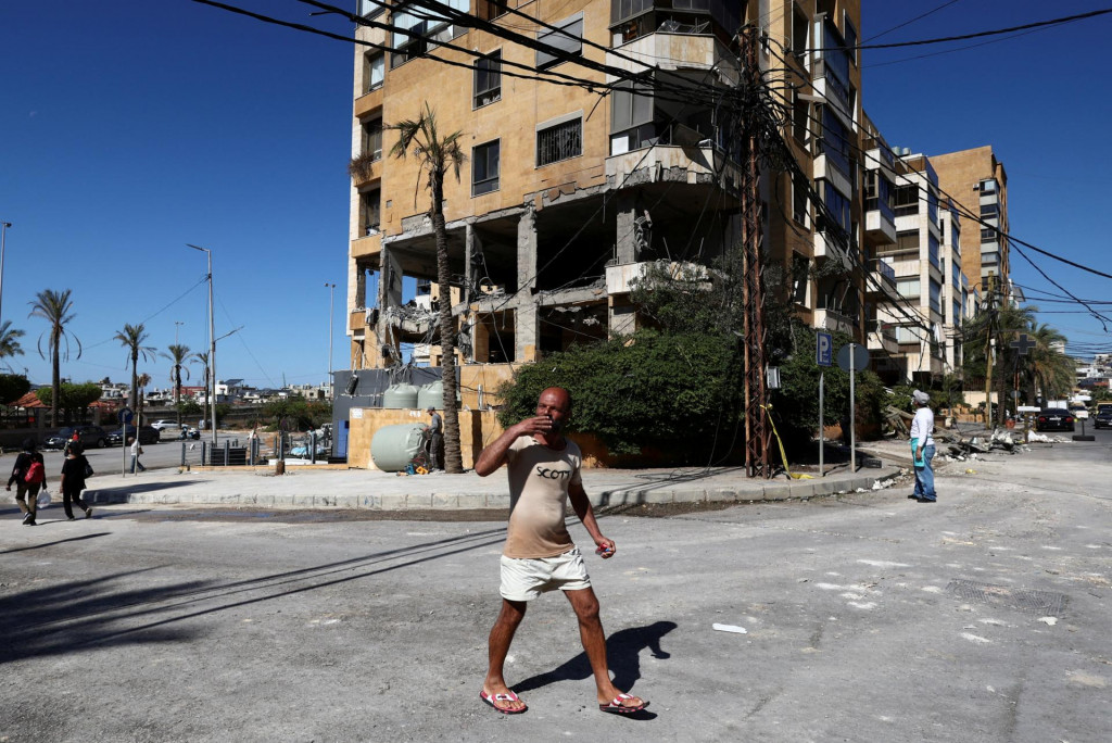 Muž kráča blízko miesta izraelského útoku, ktorý zničil kanceláriu používanú proiránskym vysielateľom Al-Mayadeen na predmestí Bejrútu. FOTO: Reuters