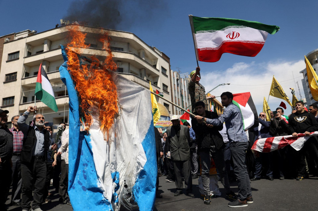 Iránci pália izraelskú vlajku počas zhromaždenia pri príležitosti Dňa Quds a pohrebu členov Zboru islamských revolučných gárd. FOTO: Reuters