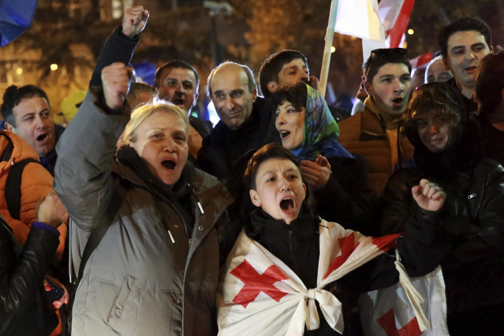 Protestujúci s gruzínskymi vlajkami počas zhromaždenia proti výsledkom parlamentných volieb, ktoré bolo údajne zmanipulované v gruzínskom meste Tbilisi. FOTO: TASR/AP