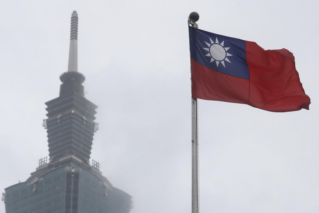 Taiwanská vlajka veje neďaleko mrakodrapu v taiwanskej metropole Tchaj-pej. FOTO: TASR/AP