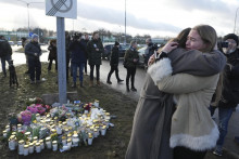 Ľudia sa zhromažďujú pri pamätníku na pamiatku obetí neďaleko miesta streľby v škole na predmestí švédskeho Örebra.
FOTO: TASR/AP