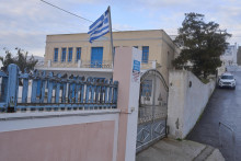 Grécka vlajka máva na zatvorenej základnej škole na obľúbenom dovolenkovom ostrove Santorini po tom, čo ostrov zasiahla vlna menších zemetrasení. FOTO: TASR/AP